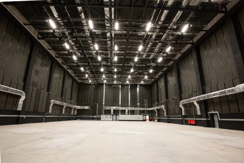 Empty soundstage with rigging lights and soundproofed black walls