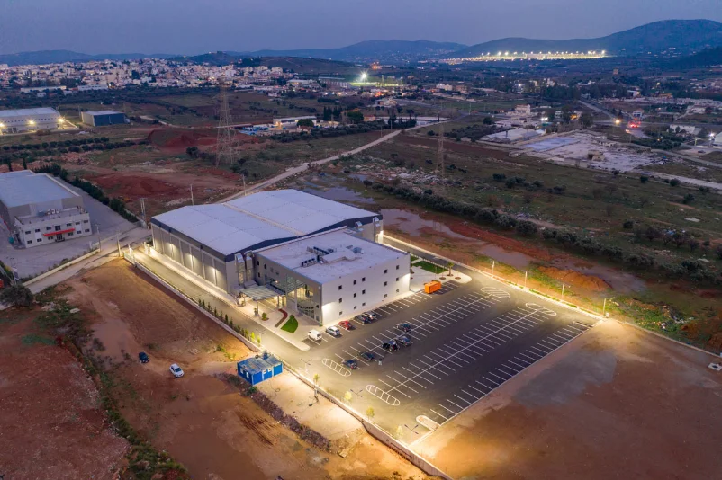 Aerial night view of a production studio complex with parking lot